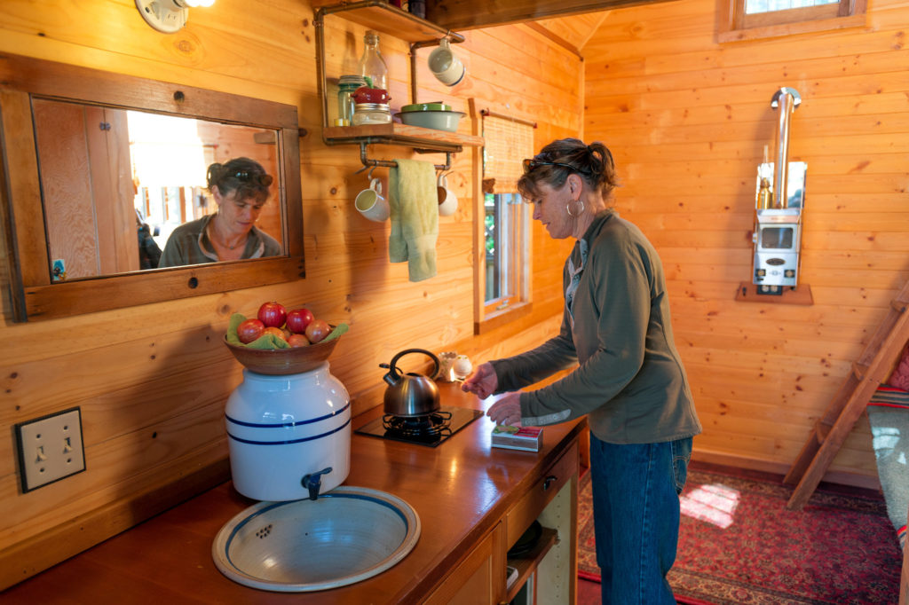 Dee Williams inside her 84 sq ft Tiny House. Photography via TInyHouseLiving.com