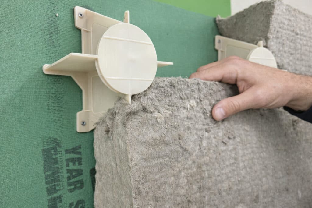 Installing batt insulation on exterior wall